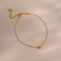 Close up of bubble initial bracelet in gold with the letter B.