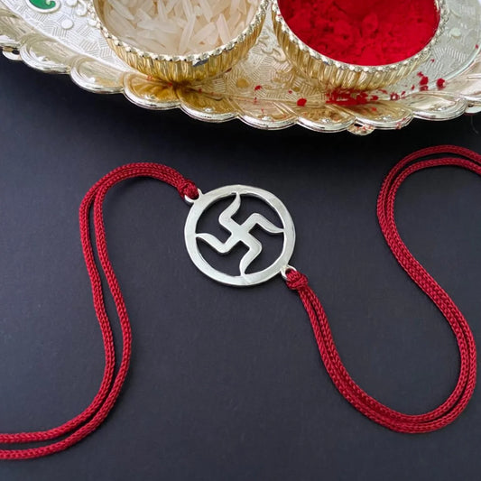 Silver Swastik Rakhi on Red Thread
