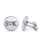Silver cufflinks with 'SOK' engraving on a white background