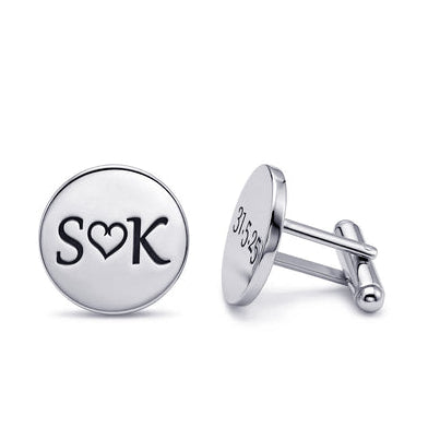 Silver cufflinks with 'SOK' engraving on a white background