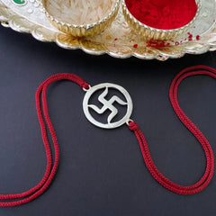 Silver Swastik Rakhi on Red Thread