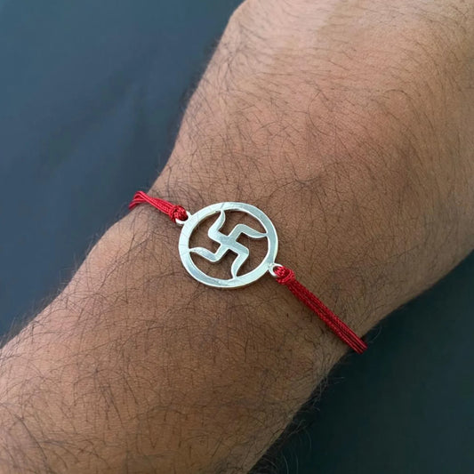 Silver Swastik Rakhi on Red Thread